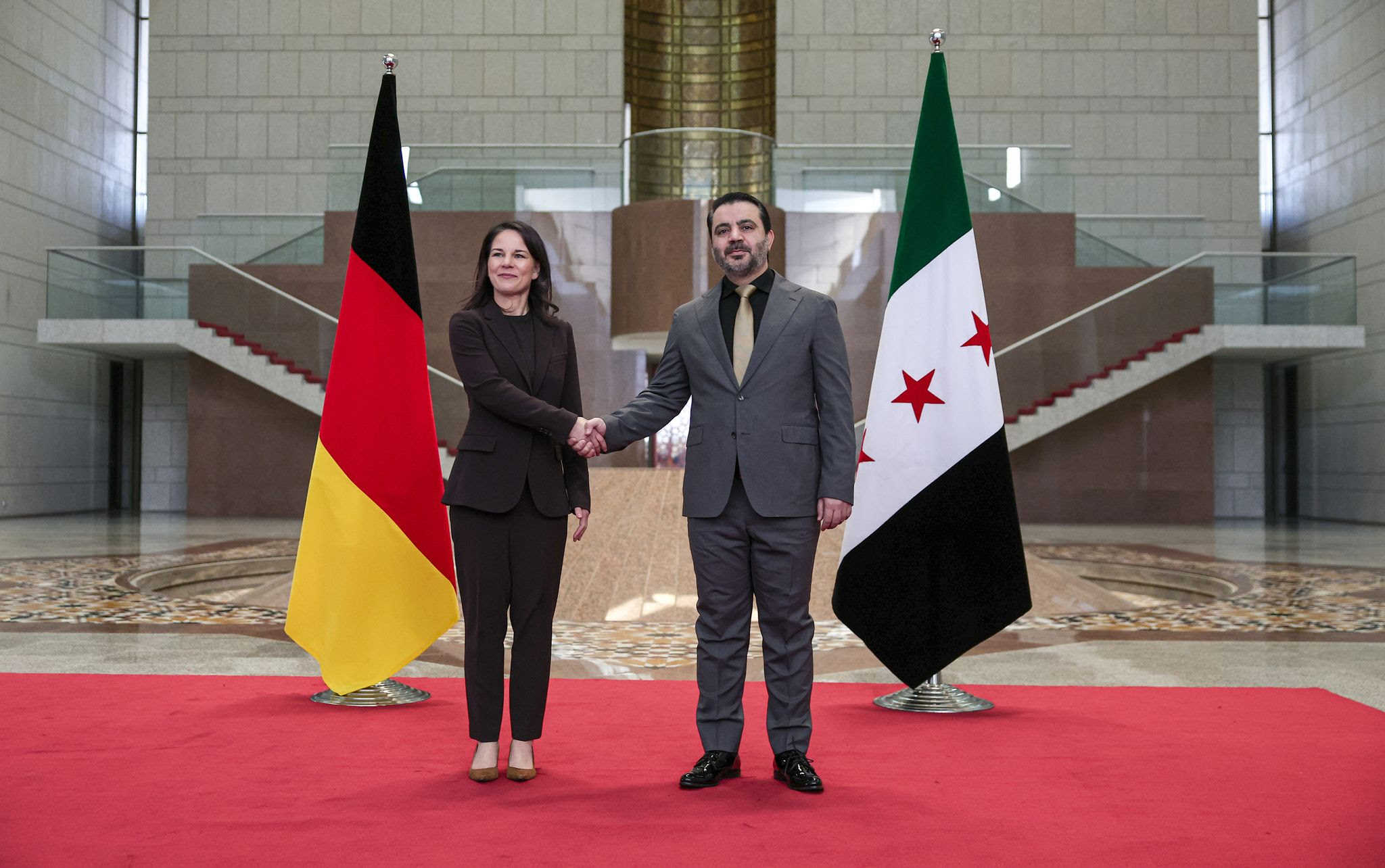 Annalena Baerbock German Federal Foreign Minister welcomed by the Syrian Foreign Minister, Assad al-Shaibani (R), at the presidential palace.