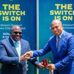 Chief of Staff, Julius Debrah (L), receives his chip-embedded passport from Foreign Affairs Minister, Samuel Okudzeto Ablakwa (R)