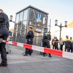 Berlin police officers stand by the Sophie-Charlotte-Platz subway entrance after an attacker stabbed and fatally injured a man during an altercation in a Berlin subway station. The police had to shoot the attacker.