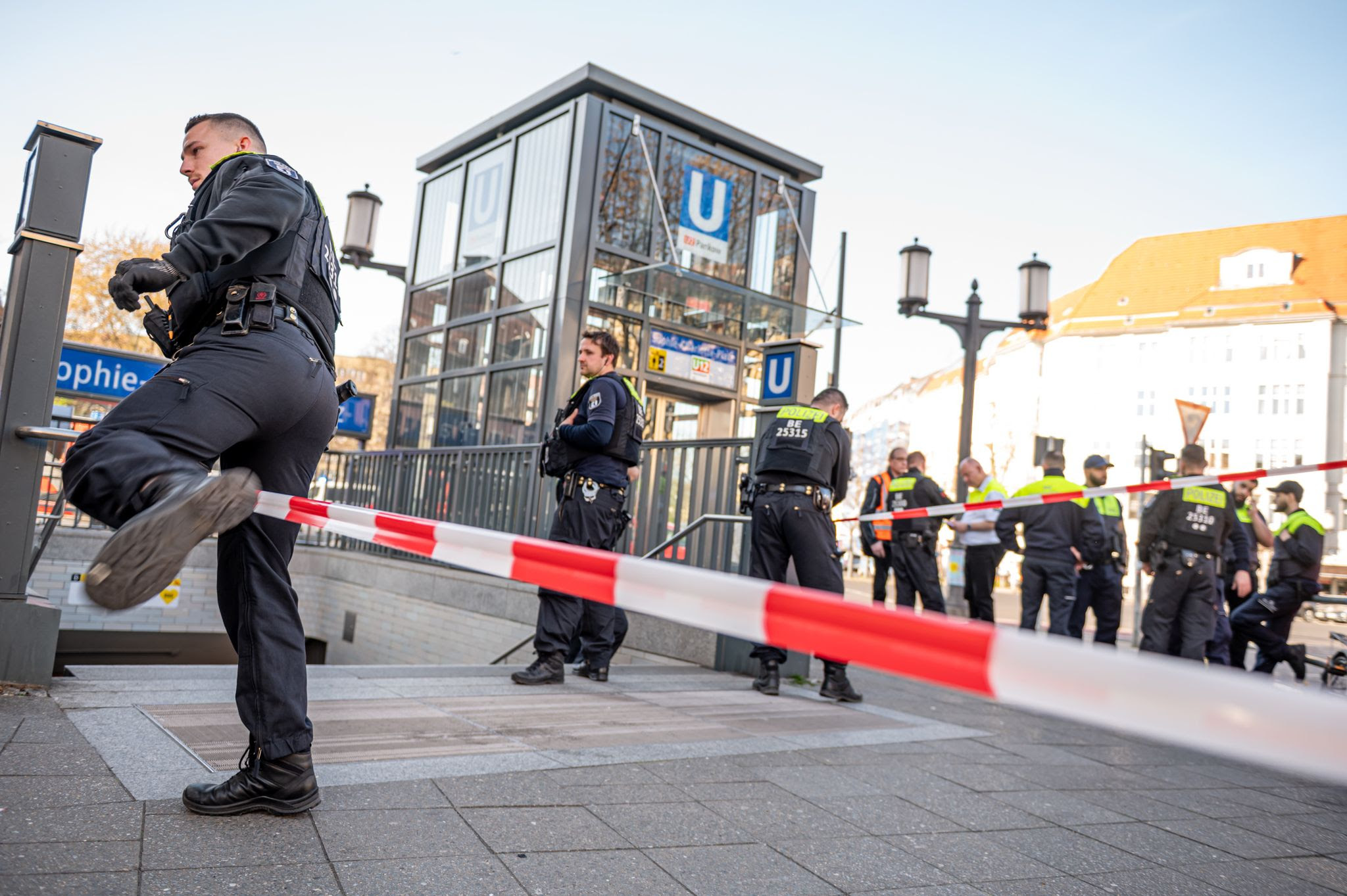 Berlin police officers stand by the Sophie-Charlotte-Platz subway entrance after an attacker stabbed and fatally injured a man during an altercation in a Berlin subway station. The police had to shoot the attacker.