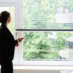 A woman stands in an office by a window and makes a phone call using a headset. The proportion of women in top management and supervisory boards at Germany's largest companies has reached record levels, according to a new analysis by the organization Women in Supervisory Boards (Fidar), which was provided to dpa.