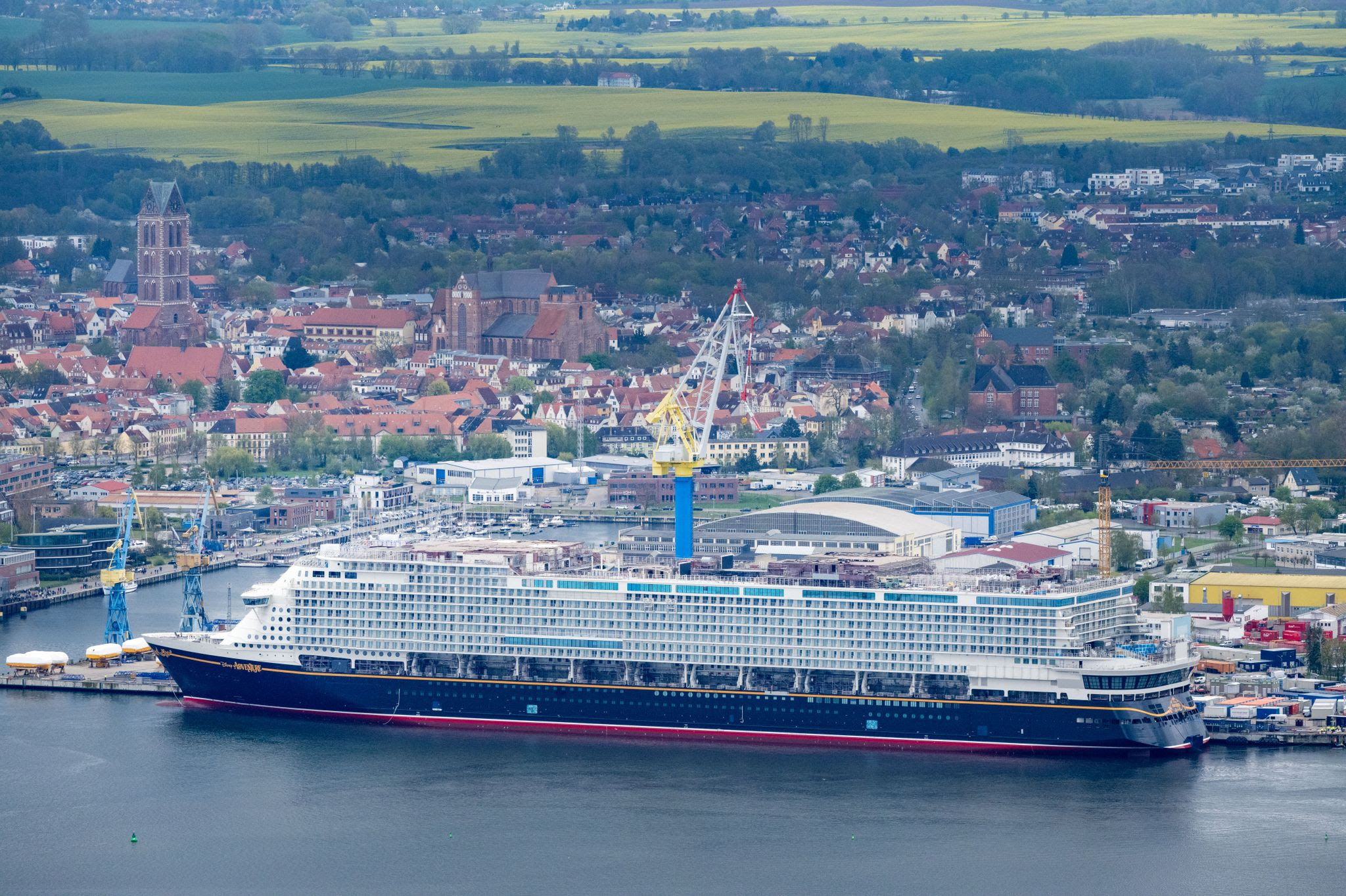 The cruise ship "Disney Adventure" is moored at the outfitting quay in Wismar on the German Baltic coast after leaving the shipbuilding hall.