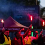 Employees with burning torches stand in front of the Ford plants in Cologne during the first strike. A strike is taking place for the first time at the Ford plants in Cologne. The protest action against planned job cuts at the site with 11,500 employees is to begin on Wednesday morning and last until the end of the night shift on Thursday morning, according to IG Metall.