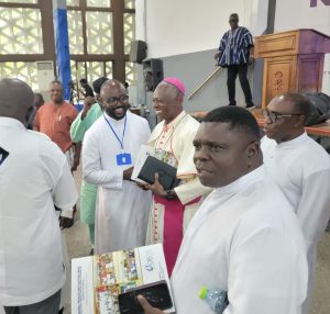 Head of Governance, Peace and Justice of the National Catholic Secretariat Rev Father Michael Quaicoe (Blue tag) interacting with President of CBC, Most. Rev. Father Mathew Kwesi Antwi.