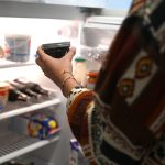 FILED - 03 July 2024, Berlin: A woman takes a jar of jam out of the fridge at home. Roughly 17 million people in Germany were living alone last year, or more than one in five, according to data from the Federal Statistical Office released on Wednesday.