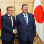German Foreign Minister Johann Wadephul (L) and Japan's Prime Minister Shigeru Ishiba (R) greet each other before their talks.