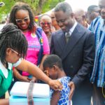 Nurse administers HPV Vaccine, Health Minister Akandor looks on