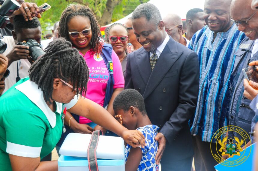Nurse administers HPV Vaccine, Health Minister Akandor looks on