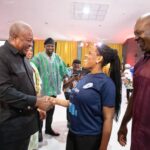 President John Mahama(left) interacting with a person with disabilities.