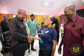 President John Mahama(left) interacting with a person with disabilities.