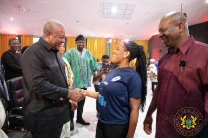 President John Mahama(left) interacting with a person with disabilities.