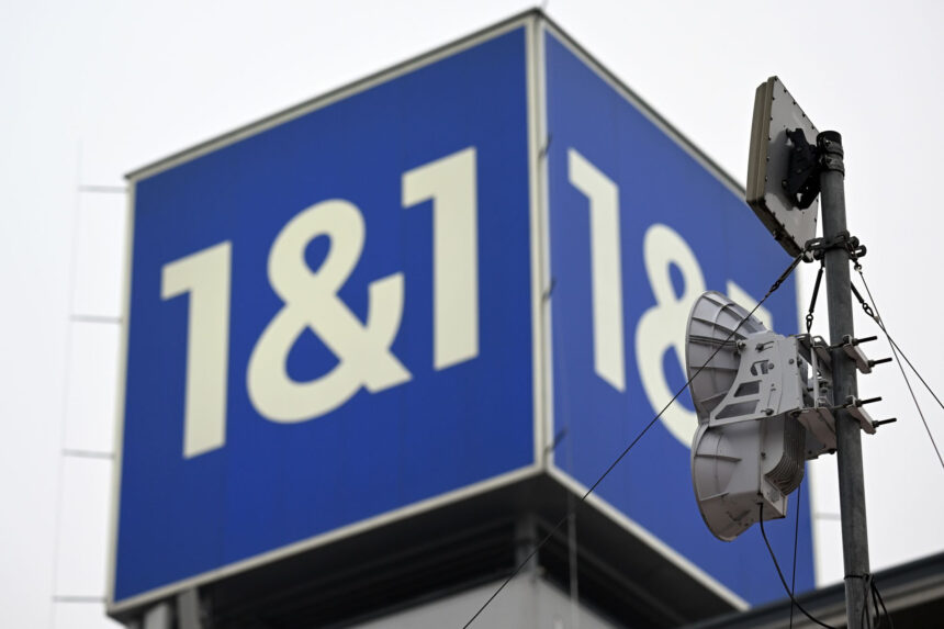 08 December 2023, Rhineland-Palatinate, Montabaur: The logo of the telecommunications provider 1&1 stands on the roof of the company headquarters. 1&1 plans to officially launch its mobile services on Friday afternoon. At the end of September, 60 antenna sites were ready for cell phone connections; 200 are to be activated by the beginning of 2024. Photo: Federico Gambarini/dpa