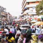Trade Minister at Markets in Accra, advocating fair pricing.
