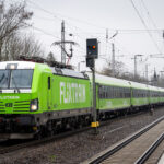 22 March 2024, Brandenburg, Trebbin: A Flixtrain passes Trebbin station. Photo: Soeren Stache/dpa