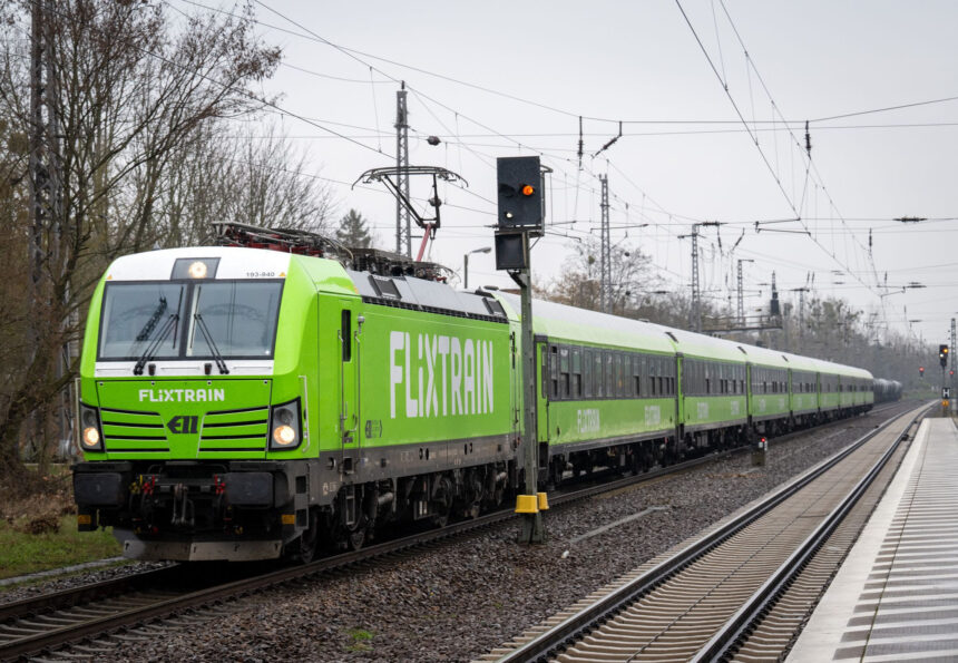 22 March 2024, Brandenburg, Trebbin: A Flixtrain passes Trebbin station. Photo: Soeren Stache/dpa