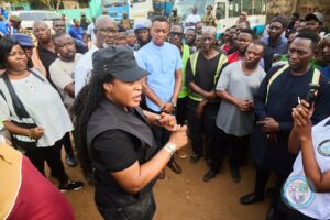 Tema Metropolitan Assembly Chief Executive, Ebi Bright (in black) leads clean-up campaign in city.