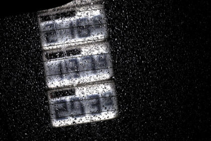 Gasoline and diesel prices can be seen on the display board of a gas station behind a rain-wet car window. Photo: Karl-Josef Hildenbrand/dp
