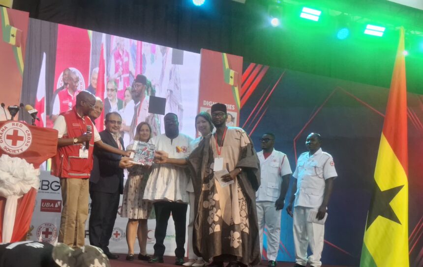 Dr. Donkoh, (in White Fugu), receiving Red Cross Report at World Red Cross Celebration in Accra.