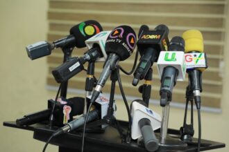 Journalists ready with mics for press conference at Press Center in Accra