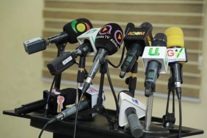 Journalists ready with mics for press conference at Press Center in Accra
