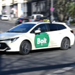 A cab with the Bolt logo drives along a road in Berlin. Photo: Michael Brandt/dpa
