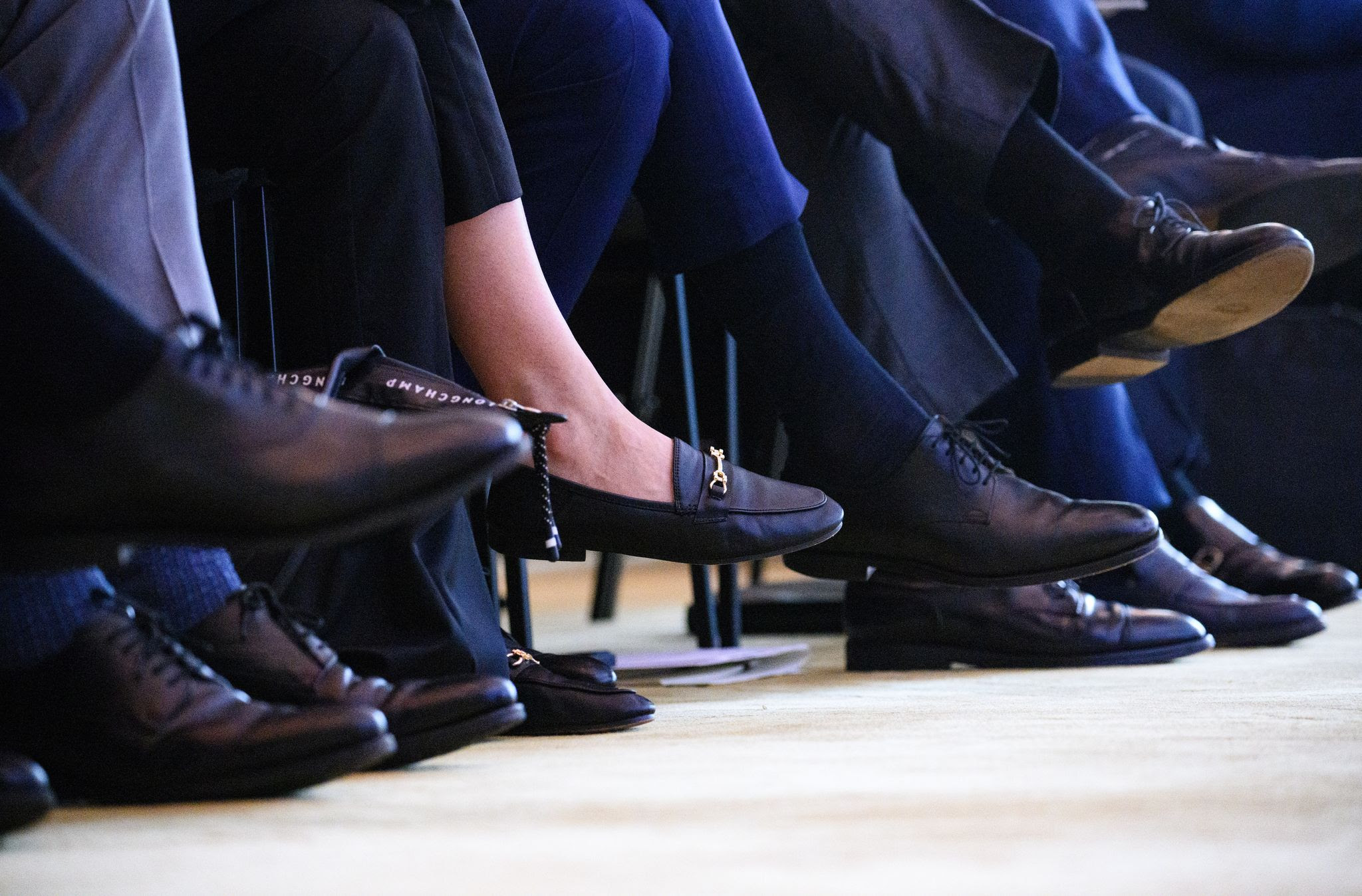 A woman sits among numerous men at the Family Business Day 2024 at the Hotel Adlon. Photo: Bernd von Jutrczenka/dpa