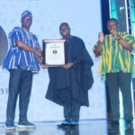 Albert Dumfour (middle) hands over Champion of Press Freedom Award to Samson Ayenini-with Communications Minister, Sam George (right)
