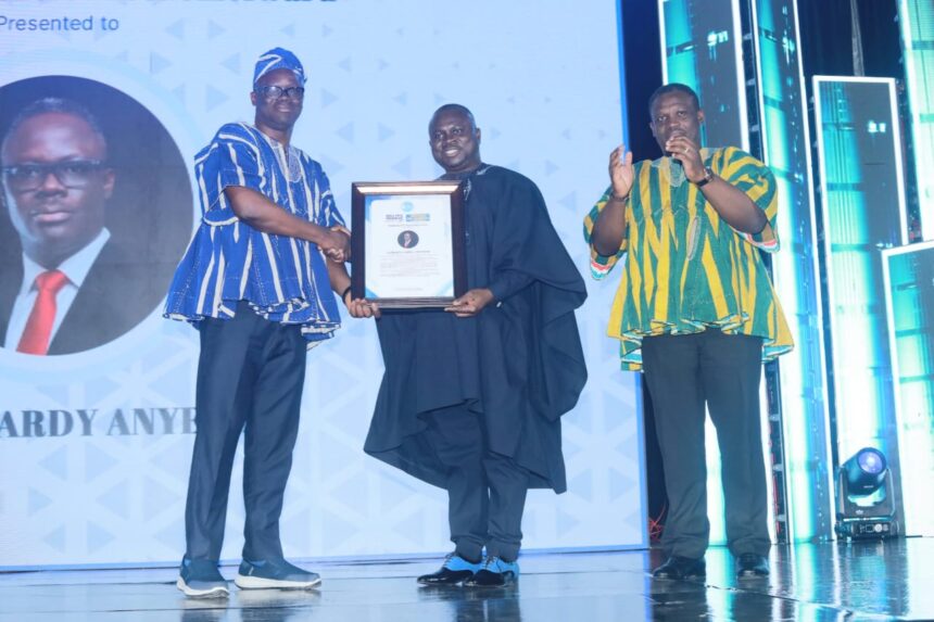 Albert Dumfour (middle) hands over Champion of Press Freedom Award to Samson Ayenini-with Communications Minister, Sam George (right)