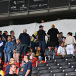 A white sheet has been stretched out due to an emergency medical response as spectators stand and sit in the stands during the German 2nd Bundesliga soccer match between Eintracht Braunschweig and SG Dynamo Dresden at Eintracht Stadium. Photo: Swen Pförtner/dpa